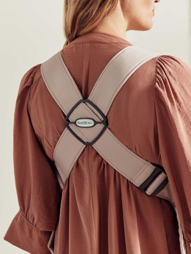 Marketing image of Baby Bjorn Mini Carrier showing cross straps on back