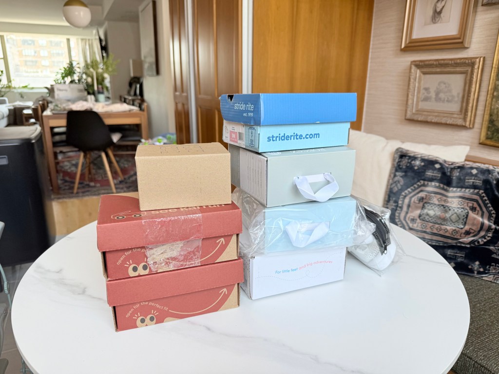 Image of shoe boxes stacked on a kitchen table